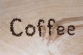 Word coffee laid out from grains on a wooden background Royalty Free Stock Photo
