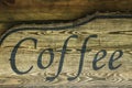 The word coffee on old wooden background.