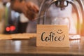 Word Coffee? on wood sign board imply to do you want coffee. Start you day with a cup of coffee