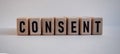 Word CONSENT, inscription on wooden cubes on white background