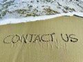 Word contact us in the sand Royalty Free Stock Photo