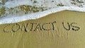 Word contact us in the sand Royalty Free Stock Photo