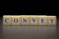 The word CONVEY written on wooden cubes isolated on a black backgrond