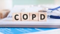 Wooden block form the word Copd with stethoscope on the doctor`s desktop. Medical concept Royalty Free Stock Photo