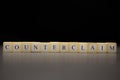 The word COUNTERCLAIM written on wooden cubes isolated on a black background Royalty Free Stock Photo