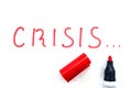 The word `crisis` written in red marker on a white background.