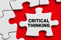 The word critical thinking on a puzzle piece