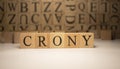 The word crony was created from wooden cubes. Countries and politics, people Royalty Free Stock Photo