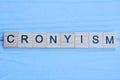 word cronyism made of small gray wooden letters Royalty Free Stock Photo