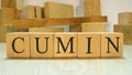 The word cumin was created from wooden letter cubes. Gastronomy and spices.