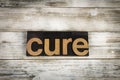Cure Letterpress Word on Wooden Background Royalty Free Stock Photo
