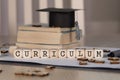 Word CURRICULUM composed of wooden dices