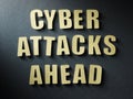 The word Cyber Attacks Ahead on paper background Royalty Free Stock Photo