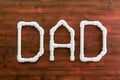 Word Dad formed of white PVC pipes on wood
