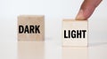 Word DARK and LIGHT on wooden block