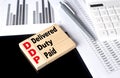 Word DDP made with wood building blocks with chart and calculator Royalty Free Stock Photo
