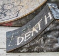 Wooden small ramp on sidewalk with word Death