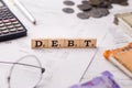 Word DEBT written on wooden cubes stock image.