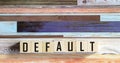 The word DEFAULT on wooden cubes.