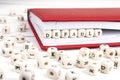 Word Default written in wooden blocks in red notebook on white w