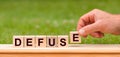 Word Defuse written with wooden blocks, concept Royalty Free Stock Photo
