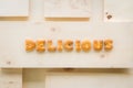 Word DELICIOUS Alphabet Biscuits on wood background Royalty Free Stock Photo