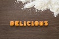 Word DELICIOUS Alphabet Biscuits on wood desk Royalty Free Stock Photo