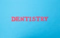 The word dentistry on a blue background. Concept sections of medicine dealing with dental treatment and problems