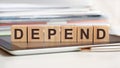 the word depend is written on wooden cubes, concept