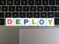 Word Deploy on keyboard background Royalty Free Stock Photo