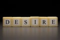 The word DESIRE written on wooden cubes, isolated on a black background