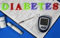 The word Diabetes on a blue background, next to an insulin syringe