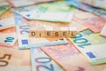 The word Diesel on banknotes Euro notes written with wooden cubes