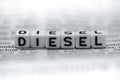 Word DIESEL formed by wood alphabet blocks on newspaper