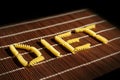 Word DIET with pasta elements on brown table set Royalty Free Stock Photo