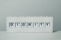 Word dignity in a wooden split flap board Royalty Free Stock Photo