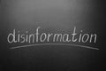 Word DISINFORMATION written on blackboard, closeup view Royalty Free Stock Photo