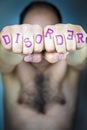 The word DISORDER written on the fists of a man