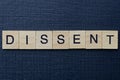 Word dissent from gray wooden letters