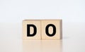 Word do. Top view of wooden blocks with letters on white surface Royalty Free Stock Photo