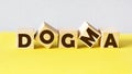 Word DOGMA made from building on light background