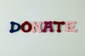 The word Donate formed with colorful felt letters Royalty Free Stock Photo