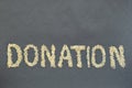 The word donate made from cereals on a black background