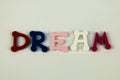 The word Dream formed with colorful felt letters