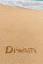 The word Dream written in the sand on the beach