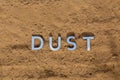 The word dust on dusty road surface in flat lay perspective