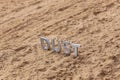 The word dust standing on dusty road surface in linear perspective