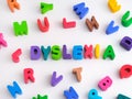 The word Dyslexia made out of play clay letters with other play clay letters surrounding it