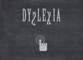 The word dyslexia written on a black chalkboard