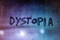 the word dystopia handwritten on wet window glass surface